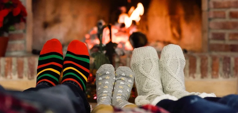 Warm feet by fireplace representing warming up target accounts before sales outreach